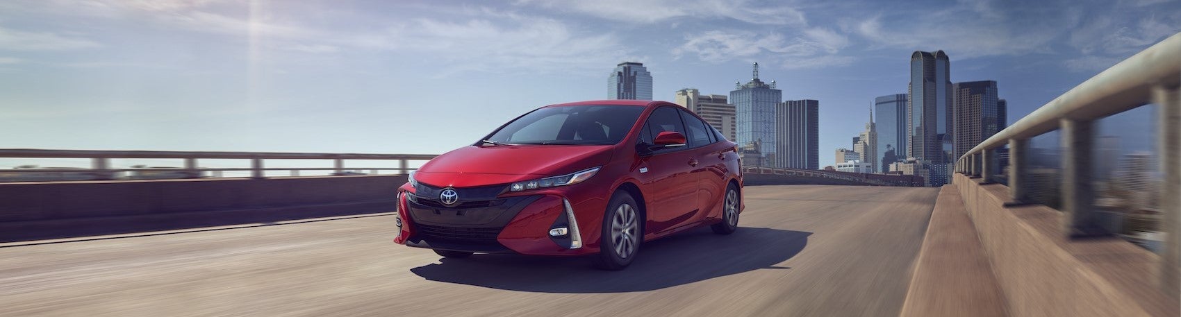 Red Prius driving on a highway